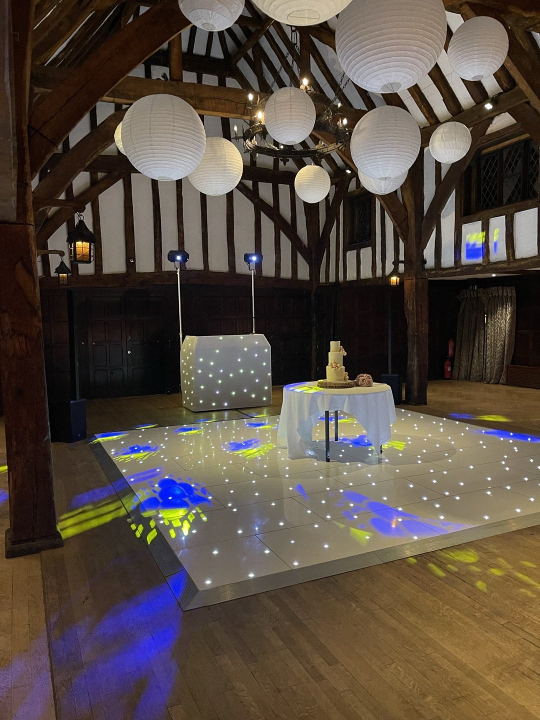 A DISCOAGOGO setup in a timber-framed room, with lanterns and a lit dance floor