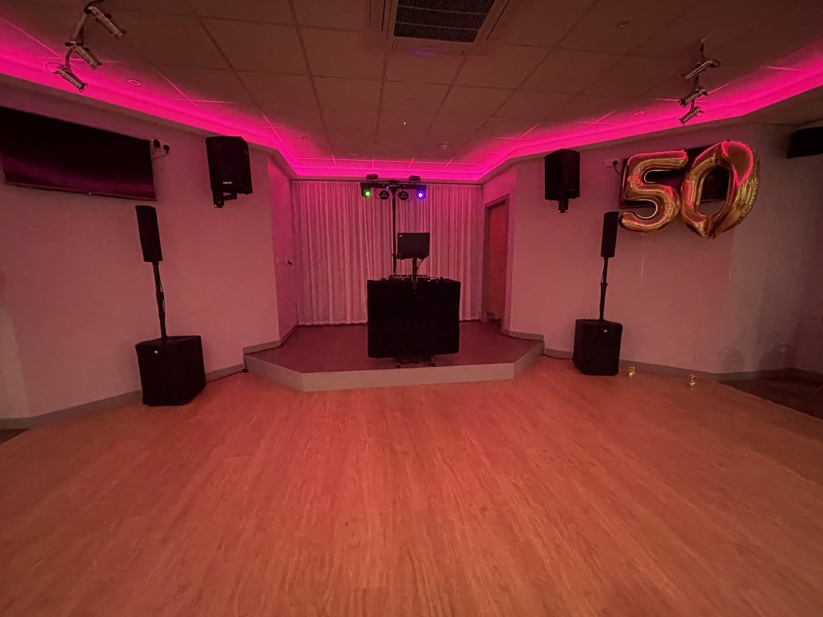 Comrades Club Epsom · A black booth and pink lighting, ready for a golden-anniversary party