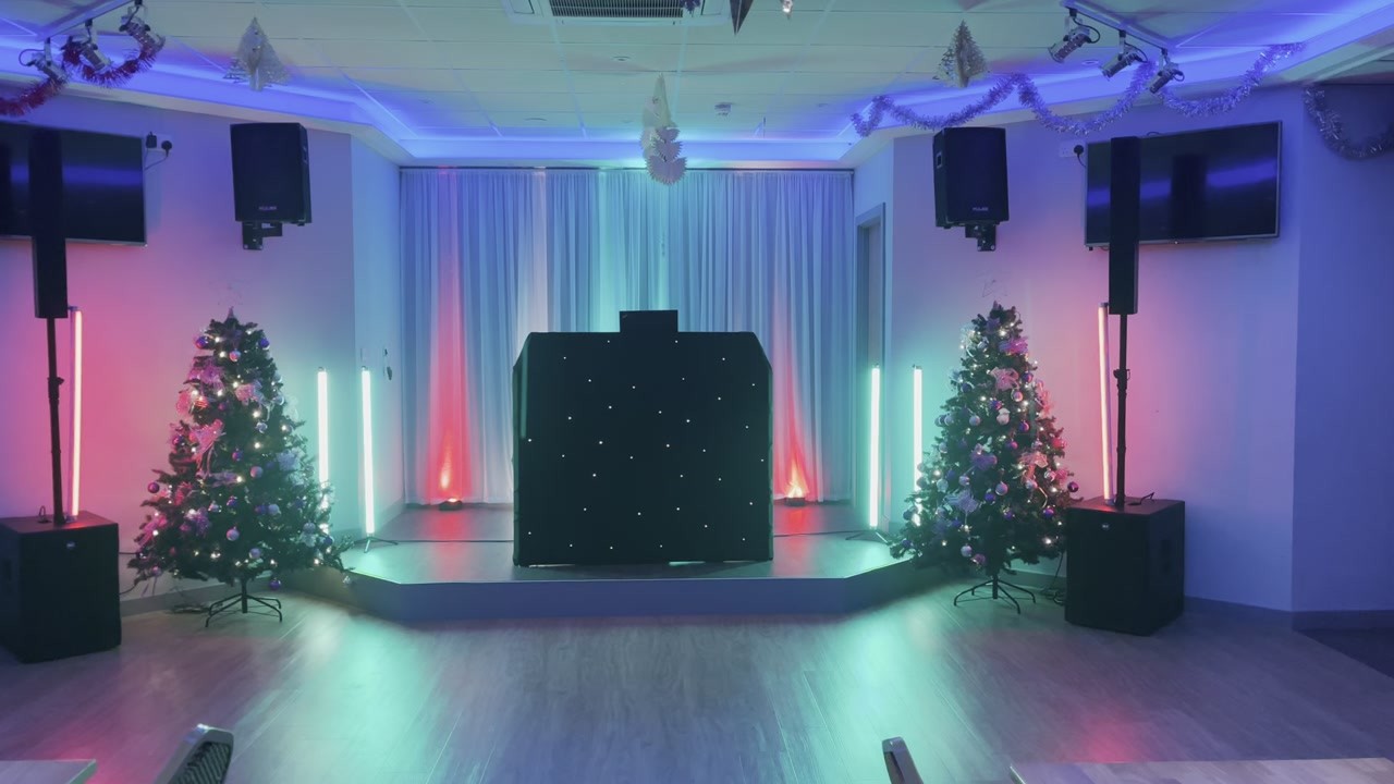 Comrades Club Epsom · A black booth, red uplighting and Christmas trees, ready for a festive party — video still